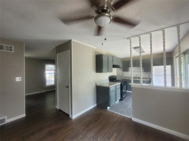 kitchen with dark hardwood / wood-style floors, gray cabinets, black electric range oven, and a textured ceiling