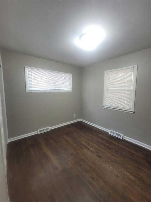 unfurnished room featuring dark hardwood / wood-style flooring