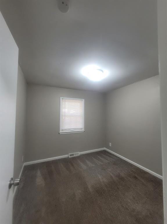 empty room with dark carpet