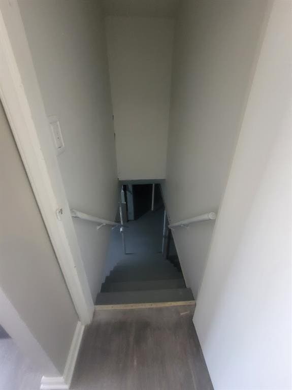 stairway featuring hardwood / wood-style floors