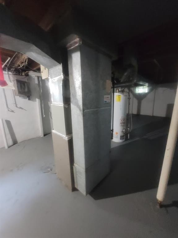 basement featuring gas water heater and heating unit