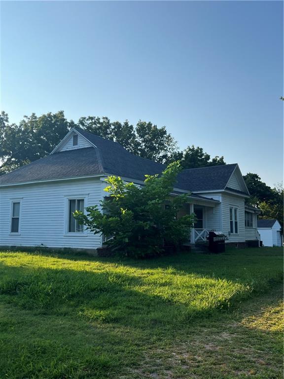 view of side of property with a lawn