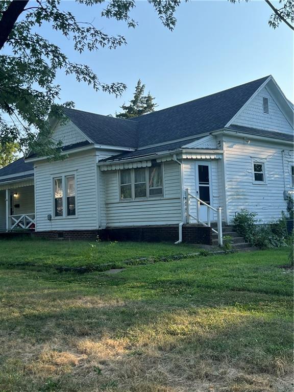 rear view of property with a yard