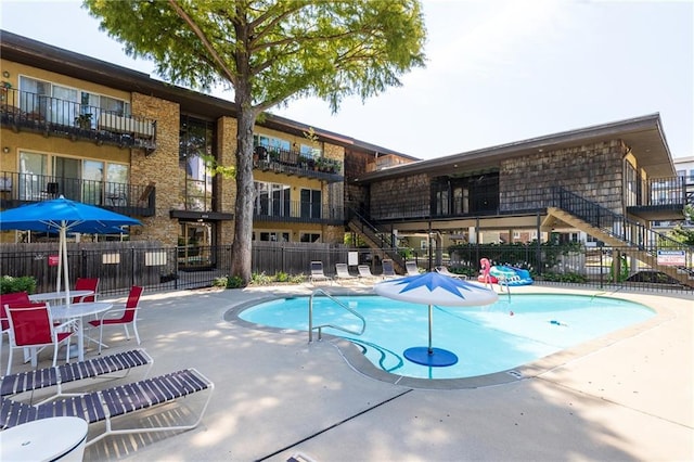 pool featuring a patio area and fence