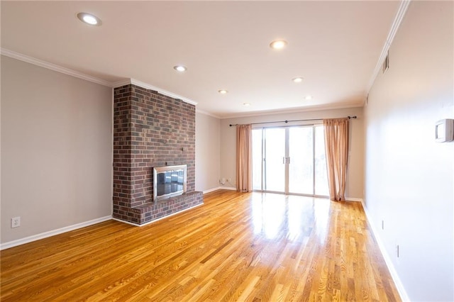 unfurnished living room featuring baseboards, crown molding, light wood-type flooring, a fireplace, and recessed lighting