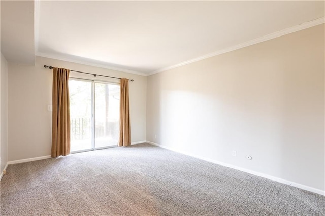 carpeted empty room with ornamental molding and baseboards