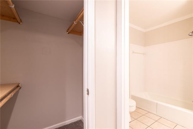 full bathroom with baseboards, toilet, ornamental molding, tile patterned floors, and bathtub / shower combination