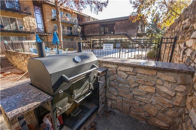 view of patio featuring grilling area and fence