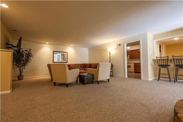 carpeted living room with visible vents and baseboards