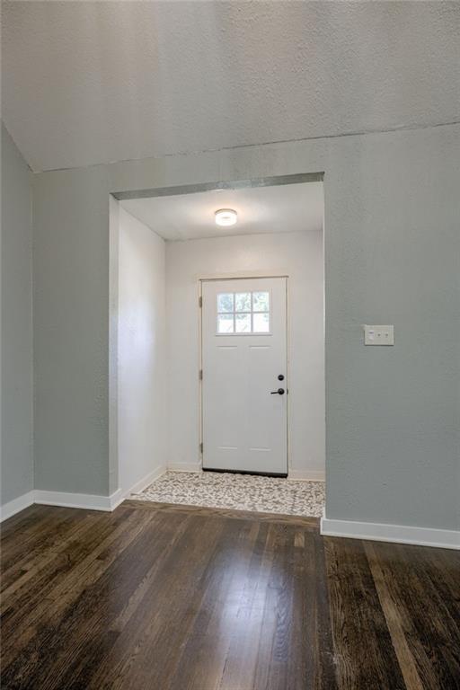 entrance foyer with a textured ceiling and hardwood / wood-style floors