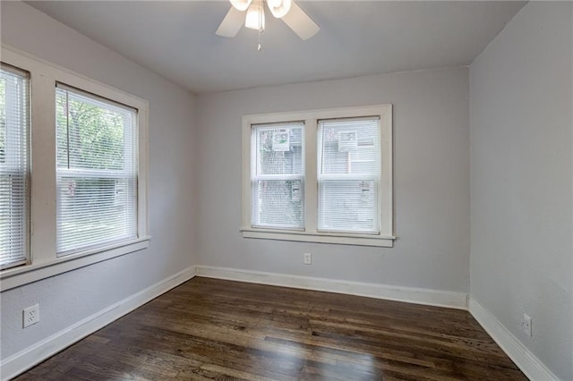 empty room featuring dark wood-type flooring and ceiling fan