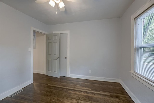 unfurnished room featuring ceiling fan and dark hardwood / wood-style flooring