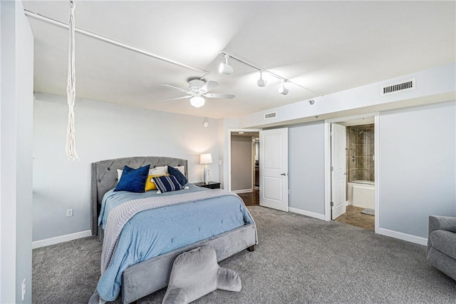 carpeted bedroom with rail lighting, ceiling fan, and ensuite bathroom