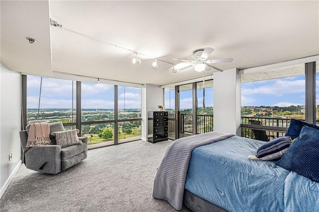 carpeted bedroom with access to outside, ceiling fan, and track lighting