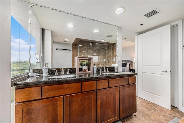 kitchen featuring light tile patterned flooring, sink, and dark stone counters