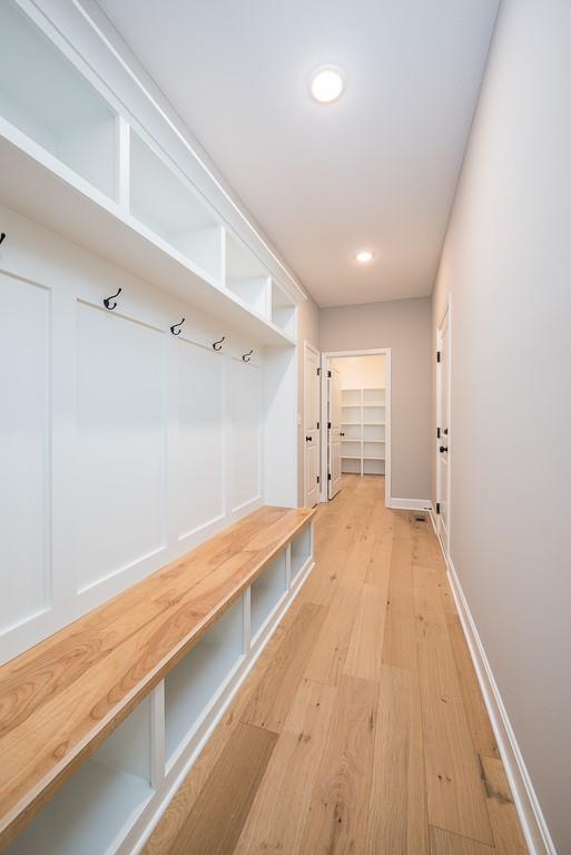 mudroom with wood-type flooring