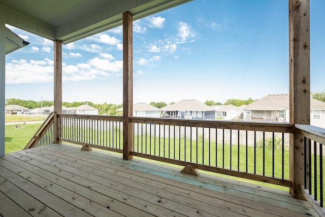 wooden terrace with a lawn