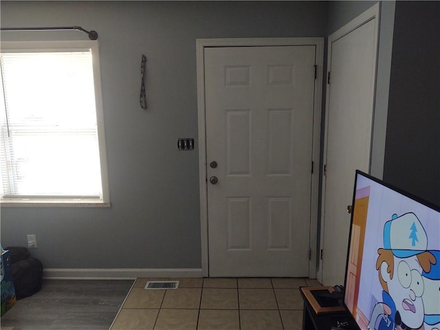 foyer featuring tile patterned flooring