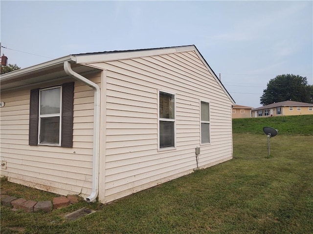 view of home's exterior with a lawn