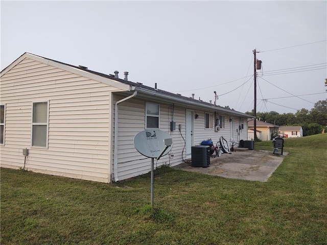 view of property exterior featuring cooling unit, a yard, and a patio