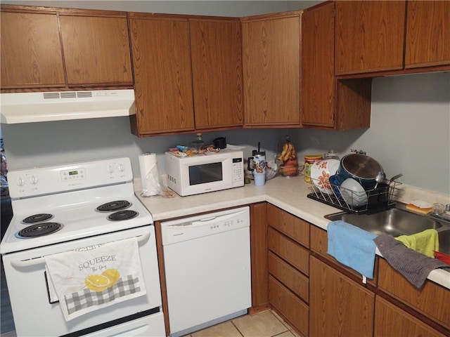 kitchen featuring light tile patterned floors and white appliances