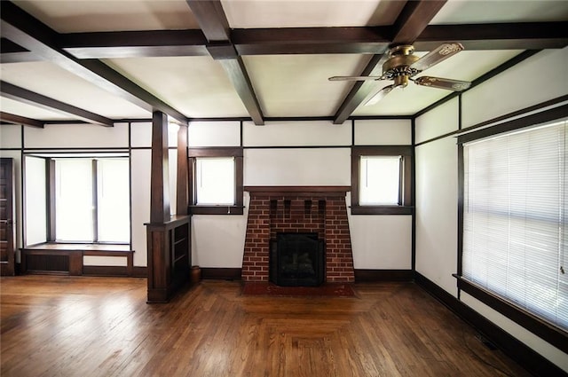 unfurnished living room with beamed ceiling, plenty of natural light, and a fireplace