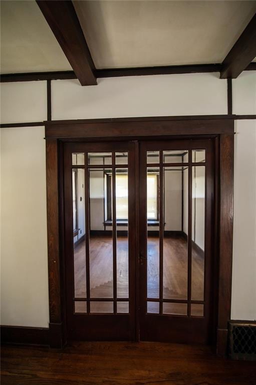 interior space featuring wood-type flooring, french doors, and beamed ceiling