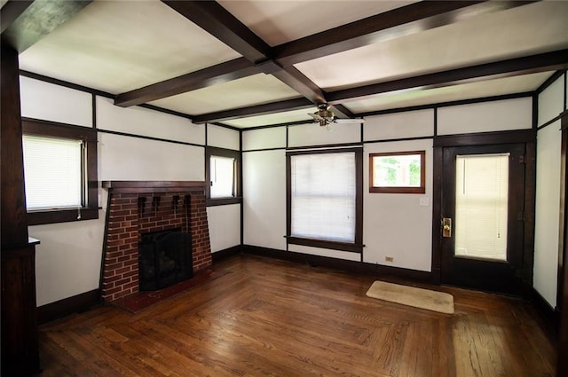 unfurnished living room with beamed ceiling, a healthy amount of sunlight, and a fireplace