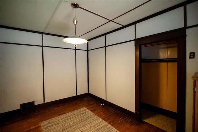 unfurnished bedroom with dark wood-type flooring