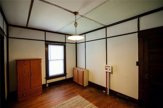 unfurnished bedroom featuring dark hardwood / wood-style floors