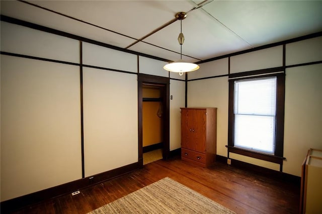 unfurnished bedroom featuring dark hardwood / wood-style floors