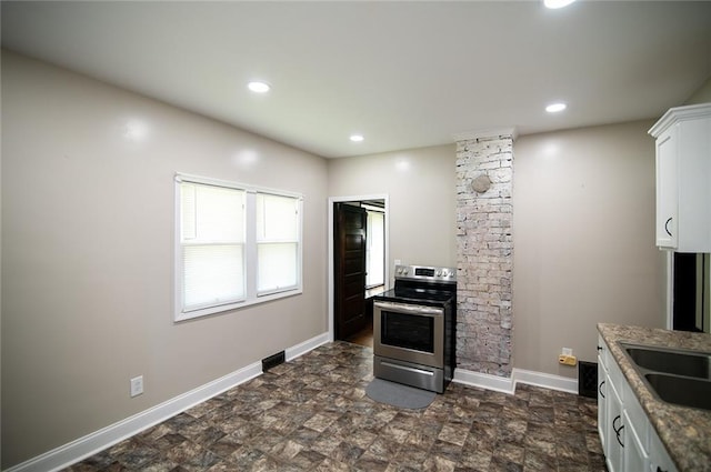 kitchen featuring white cabinetry, sink, electric range, and light stone countertops