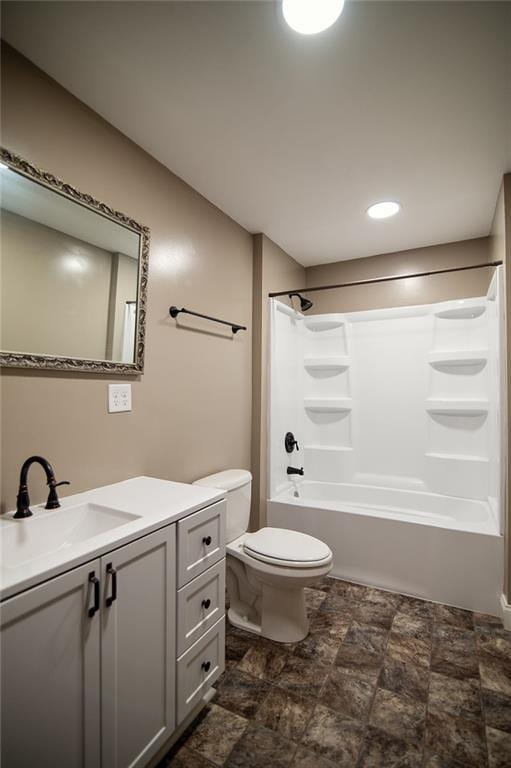 full bathroom featuring vanity, bathing tub / shower combination, and toilet