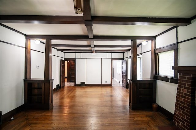 unfurnished room with beamed ceiling and dark hardwood / wood-style floors