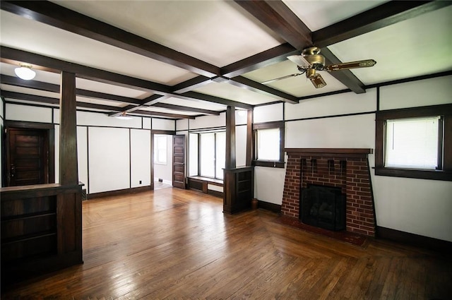 unfurnished living room with ceiling fan, hardwood / wood-style floors, beam ceiling, coffered ceiling, and a brick fireplace