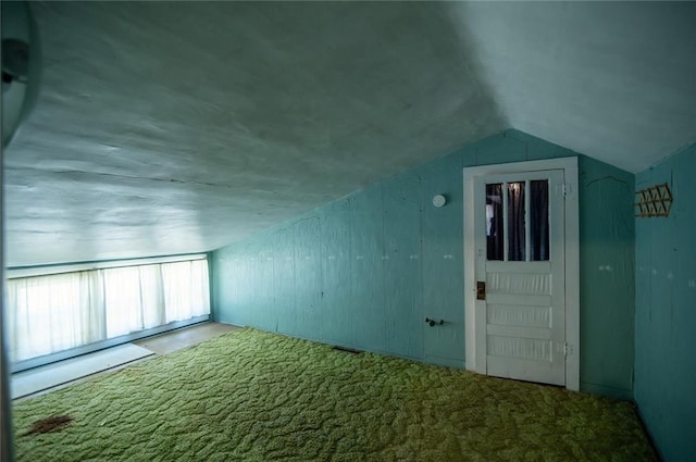 bonus room featuring lofted ceiling and carpet