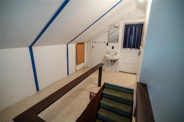 bonus room with lofted ceiling and sink