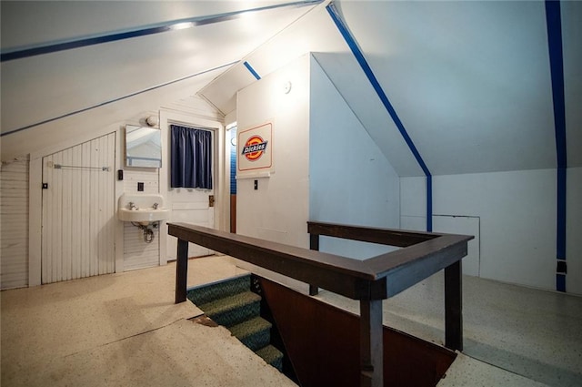 additional living space featuring lofted ceiling and sink