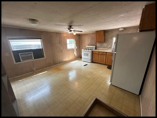 kitchen with cooling unit, white appliances, light tile patterned floors, and ceiling fan