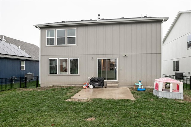 rear view of property featuring a lawn and a patio area