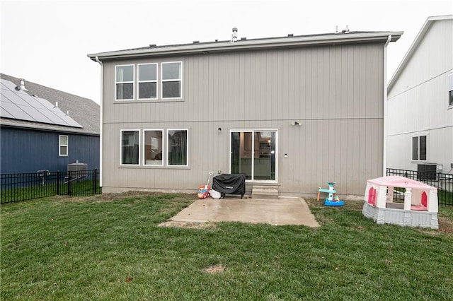 back of property with a yard and a patio