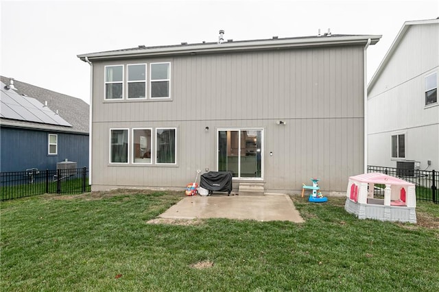 rear view of house with a lawn and a patio area