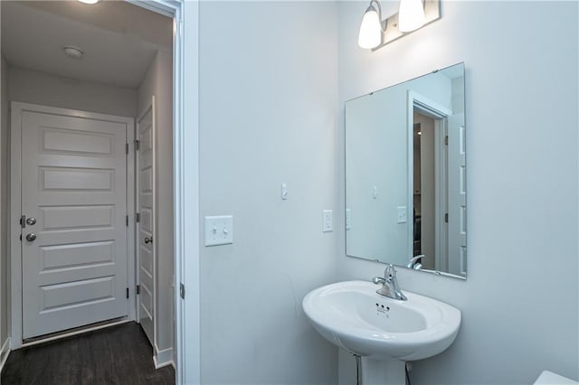 bathroom featuring wood-type flooring and sink