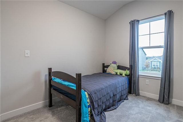 carpeted bedroom with lofted ceiling