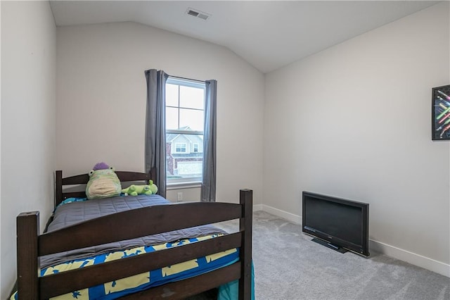 carpeted bedroom with vaulted ceiling