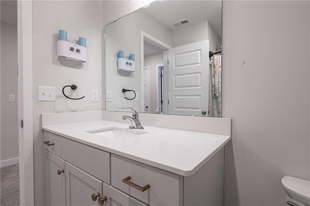 bathroom with vanity and toilet