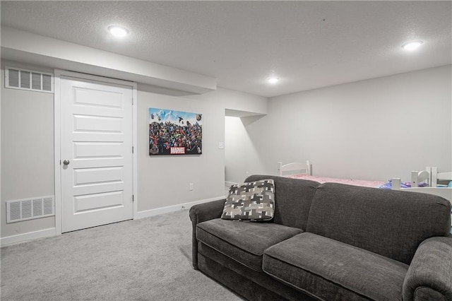 living room with carpet floors and a textured ceiling