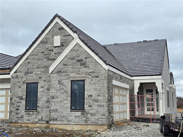 rear view of property featuring a garage