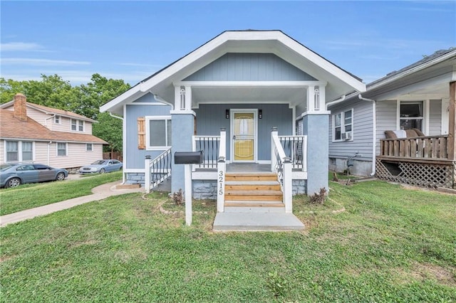 bungalow-style house featuring a porch and a front lawn