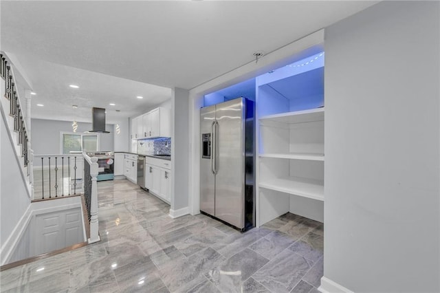 kitchen with white cabinetry, island exhaust hood, stainless steel appliances, and decorative backsplash